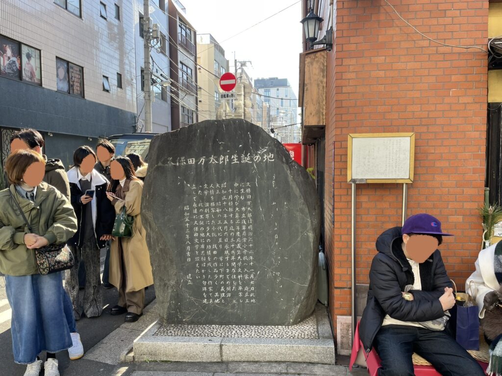 雷門通りの街角に立つ「久保田万太郎生誕の地」の碑。