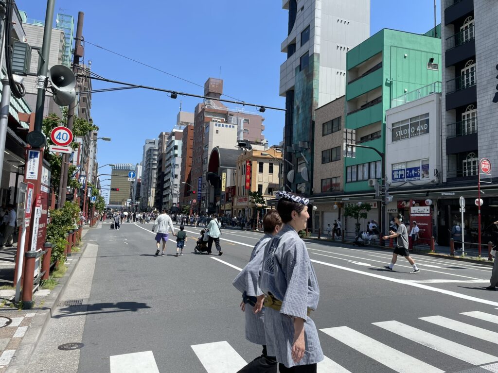浅草の街を歩く法被姿の男性。三社祭の空気が街全体に満ちています。