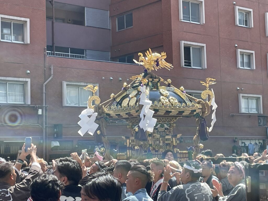 雷門通りを進む町内神輿と、それを見守る大勢の人々。