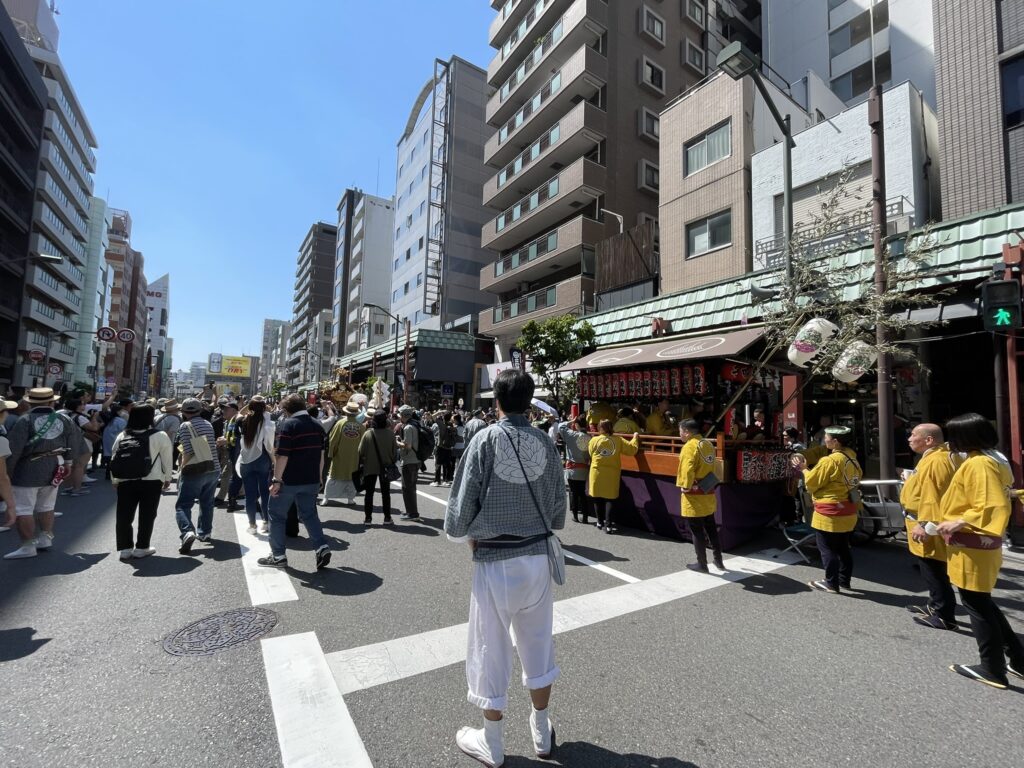 雷門通りで休憩中の担ぎ手たち。黄色い法被が目を引きます。