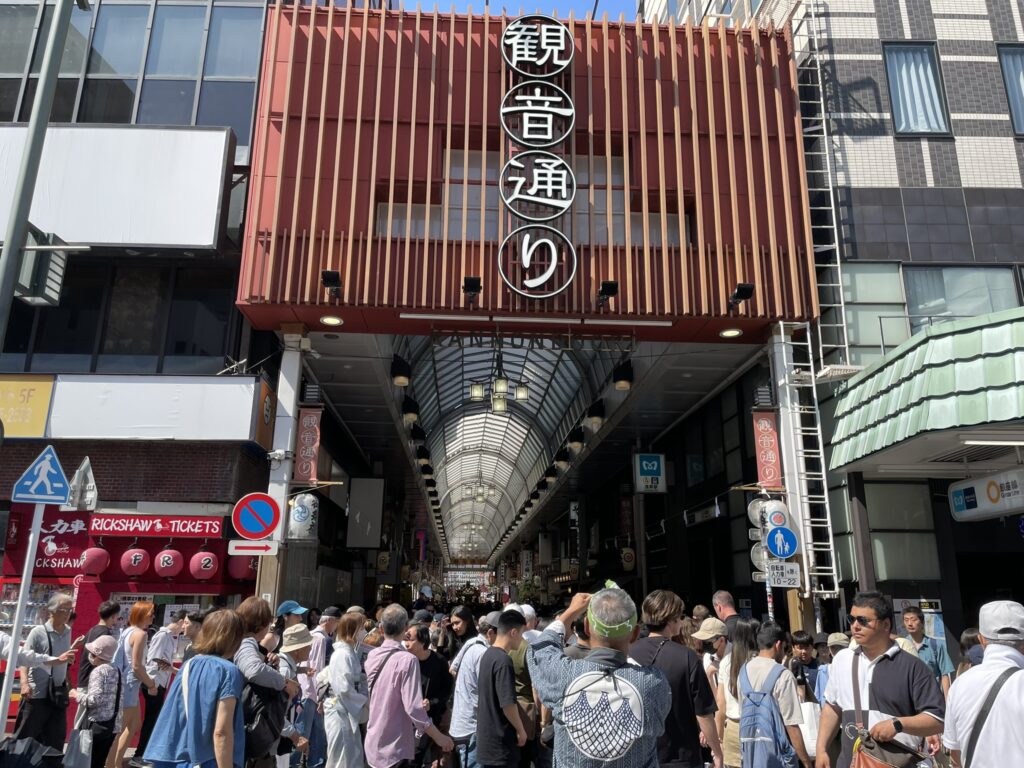 「観音通り」の看板が見える、大混雑の観音通り。三社祭最終日の熱気がピークに達しています。