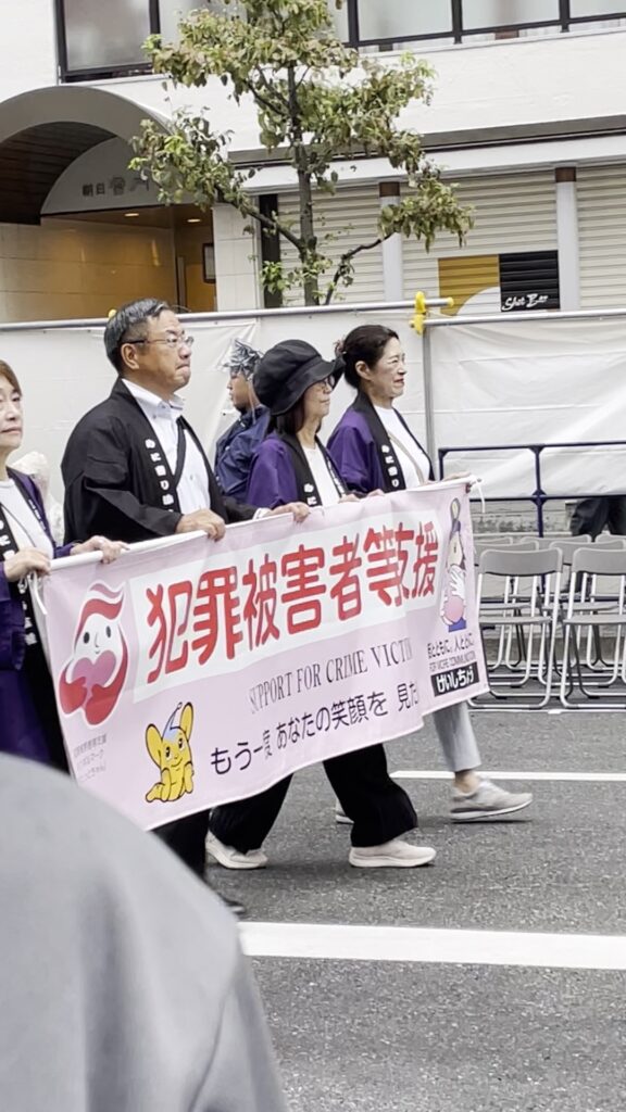 「犯罪被害者等支援」の横断幕を持って行進する浅草警察署の方々。